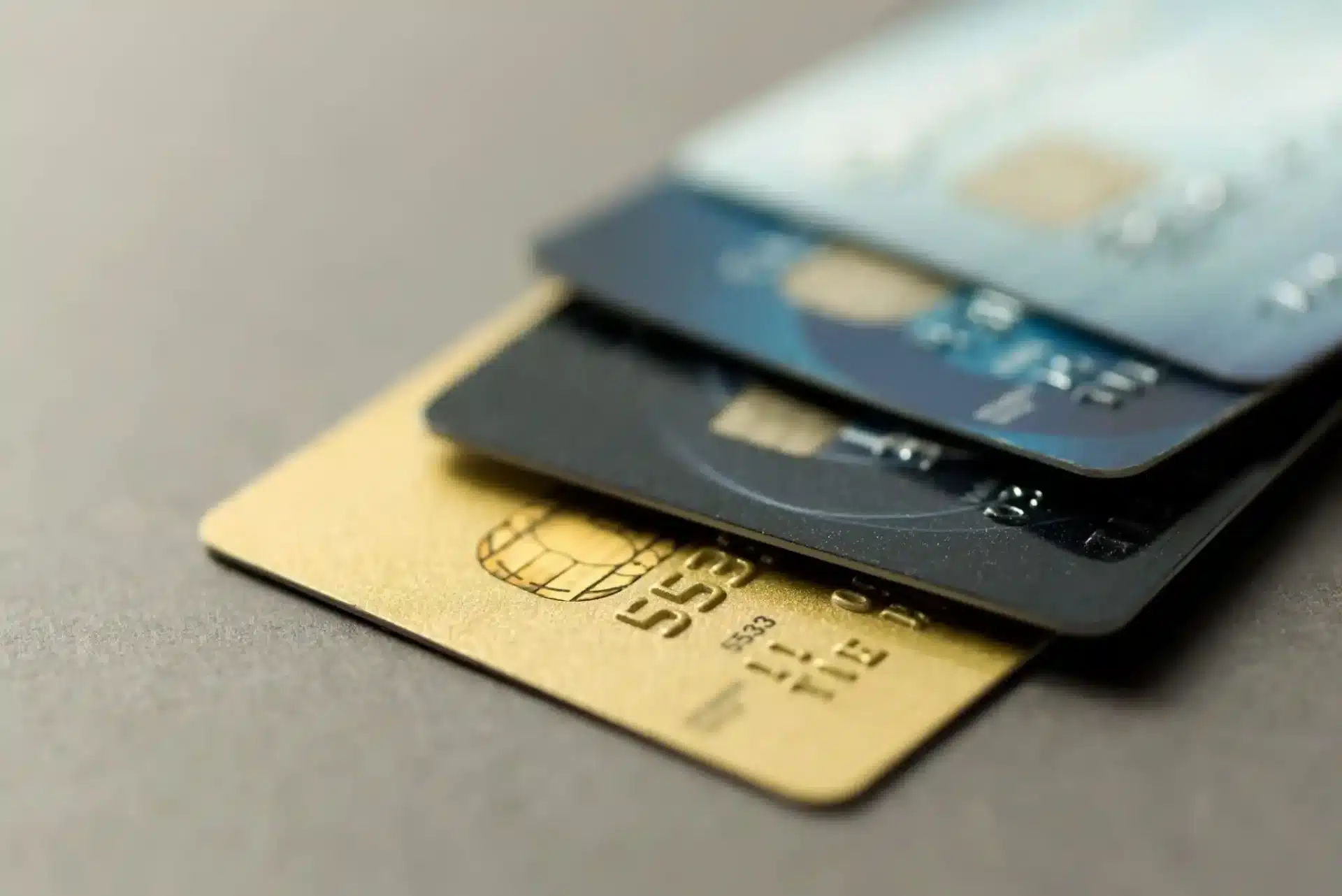 three credit cards laying on top of each other