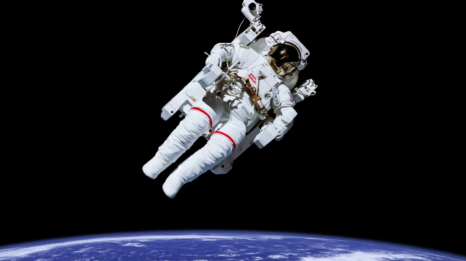 astronaut floating in space above earth