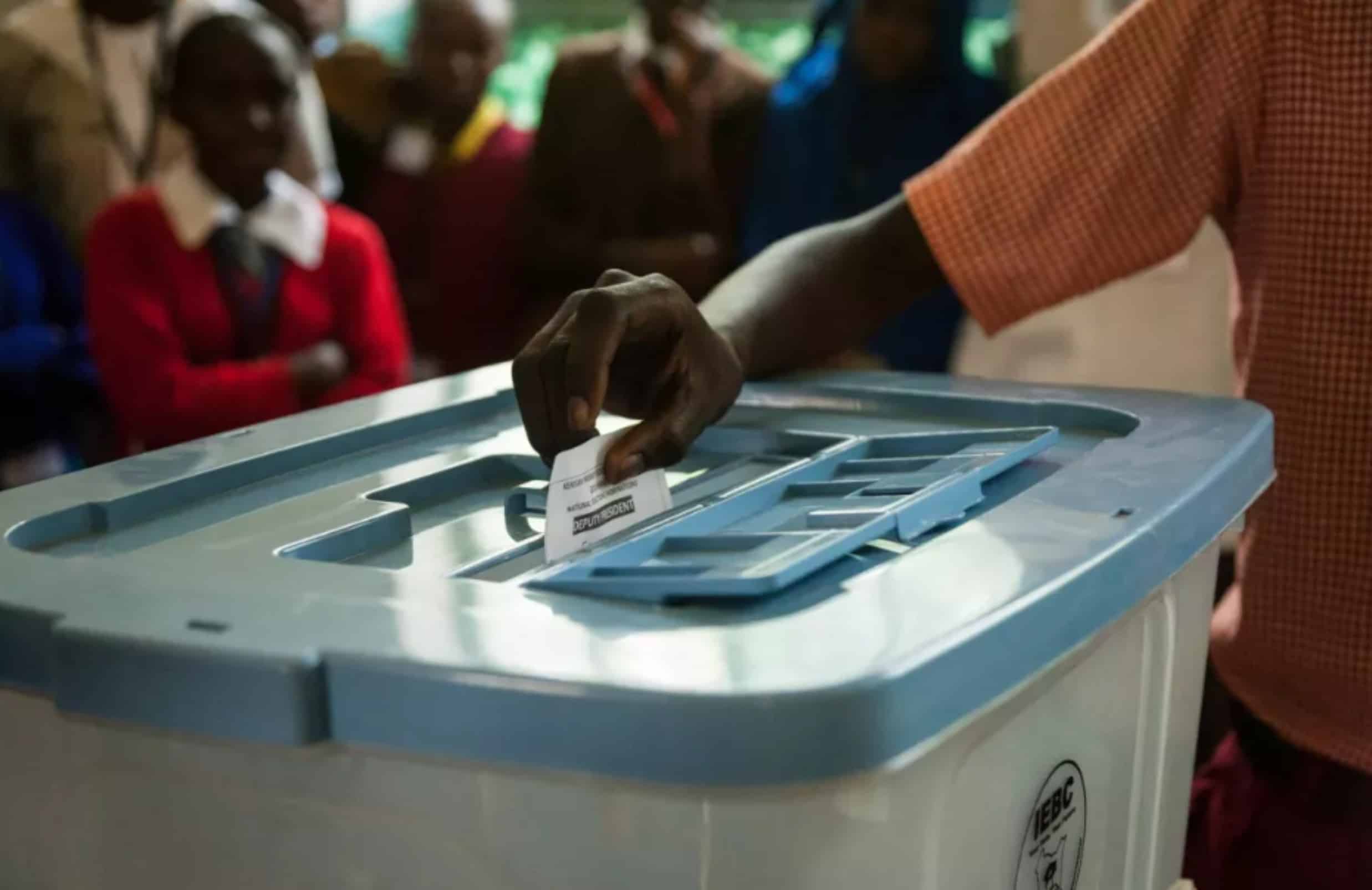 black man casting vote in a voting box