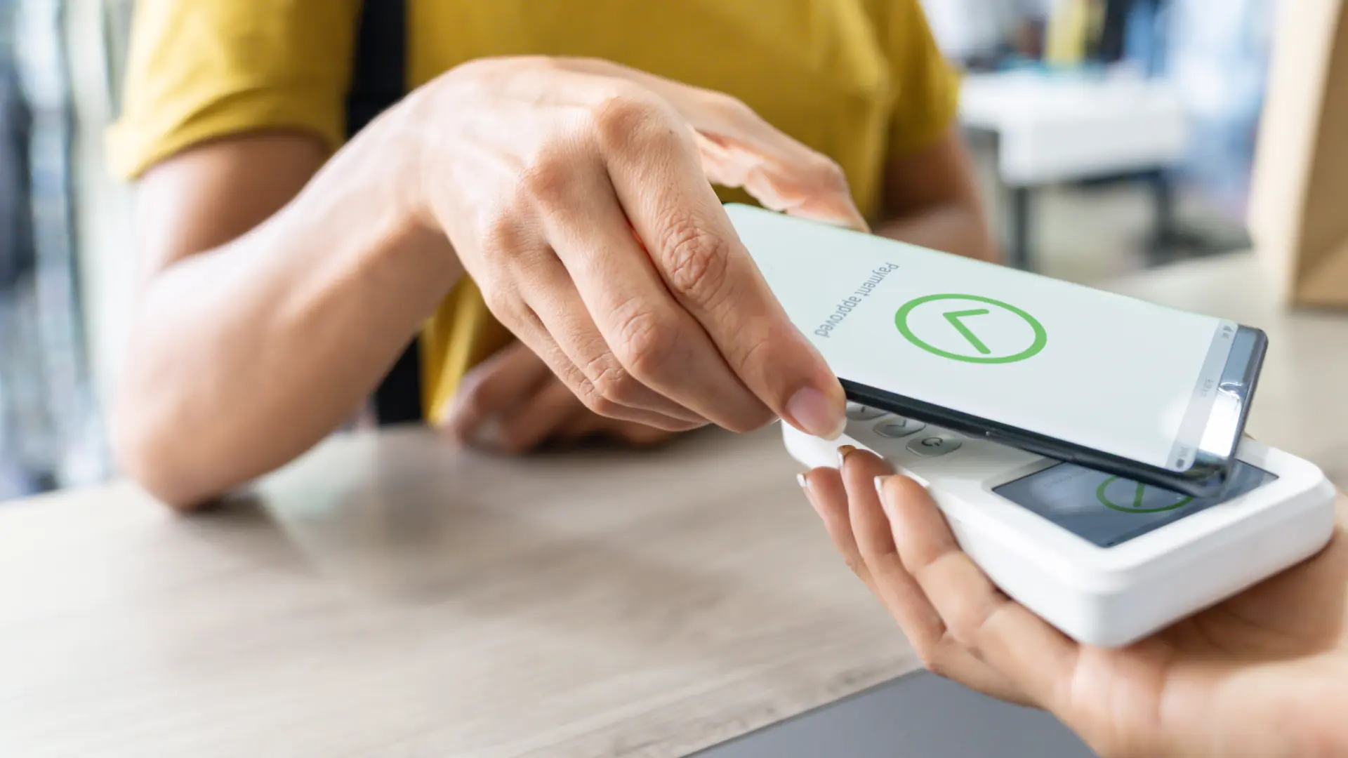Woman making a mobile payment at a clothing store