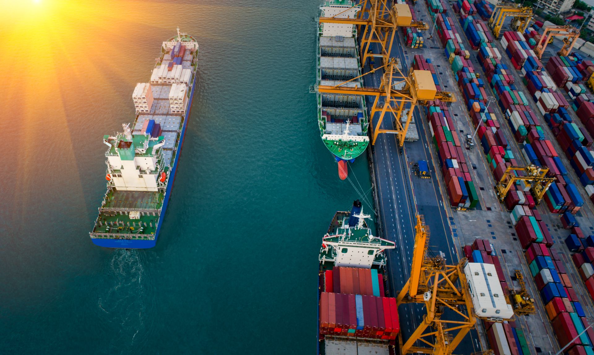 Logistics and transportation of Container Cargo ship and Cargo plane with working crane bridge in shipyard at sunset, logistic import export and transport industry background